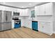 Bright kitchen features stainless steel appliances, white cabinets, and hardwood floors at 2000 Fairburn Sw Rd, Atlanta, GA 30331