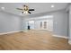 Bright living room with hardwood floors and updated lighting throughout the living space and adjoining kitchen at 2000 Fairburn Sw Rd, Atlanta, GA 30331