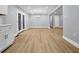 Open concept living space featuring hardwood floors, modern lighting, and an updated kitchen with stainless appliances at 2000 Fairburn Sw Rd, Atlanta, GA 30331