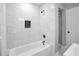 Bathroom with tiled walls, and updated shower fixtures featuring an inlaid storage shelf at 2000 Fairburn Sw Rd, Atlanta, GA 30331