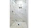 Stylish shower with mosaic stone floor and recessed shelf in an updated bathroom at 2000 Fairburn Sw Rd, Atlanta, GA 30331