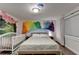 Bedroom with playful wall art, hardwood floors, and a bright, airy feel at 3071 Colonial Way # J, Atlanta, GA 30341