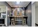 Unique dining and bar area with custom mural, stools, and decorative lighting fixtures at 3071 Colonial Way # J, Atlanta, GA 30341