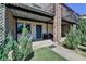 Exterior entrance of the property featuring covered patio and landscaping at 3071 Colonial Way # J, Atlanta, GA 30341