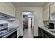 Open kitchen layout with sightlines to an adjacent work area with hardwood floors at 3071 Colonial Way # J, Atlanta, GA 30341