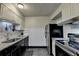 Well-lit kitchen with stainless steel appliances, granite countertops, and a modern faucet at 3071 Colonial Way # J, Atlanta, GA 30341