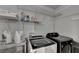 Laundry room featuring modern washer and dryer units with ample shelving space at 3071 Colonial Way # J, Atlanta, GA 30341