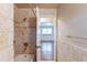 Bathroom shower with tile surround and view into secondary bedroom at 3202 Betty Cir, Decatur, GA 30032