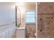 Bathroom with tile shower, handicap assist bar, single sink vanity with granite countertop and window at 3202 Betty Cir, Decatur, GA 30032