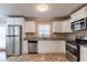 Bright kitchen with stainless steel appliances, white cabinets, and tile floors at 3202 Betty Cir, Decatur, GA 30032