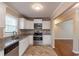 Well-lit kitchen with granite countertops, white cabinets, and stainless steel appliances at 3202 Betty Cir, Decatur, GA 30032