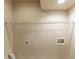 Bright laundry room with a shelf, electrical outlet, and plumbing hookups for easy appliance installation at 3202 Betty Cir, Decatur, GA 30032