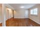 Spacious room with hardwood floors, neutral paint, and access to the hallway at 3202 Betty Cir, Decatur, GA 30032