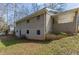 An angled view of the rear of the home with a yard and concrete patio, showing the covered porch area at 3465 Tulip Dr, Decatur, GA 30032