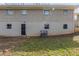 A full view of the rear of the home, showing the basement level door and upper story windows at 3465 Tulip Dr, Decatur, GA 30032