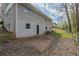 Side view of the rear of the home, showing a basement level door and a small concrete patio at 3465 Tulip Dr, Decatur, GA 30032