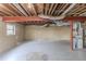 Unfinished basement featuring exposed beams, ductwork, a window, and painted block walls at 3465 Tulip Dr, Decatur, GA 30032