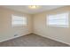 Cozy bedroom with neutral walls, plush carpeting, and natural light from two windows at 3465 Tulip Dr, Decatur, GA 30032