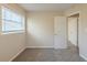A cozy bedroom featuring neutral walls, plush carpeting, and a window with blinds, providing natural light at 3465 Tulip Dr, Decatur, GA 30032