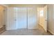 Bedroom featuring plush carpet, closet doors, and access to other rooms via paneled doors at 3465 Tulip Dr, Decatur, GA 30032