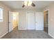 Spacious bedroom with carpeting, closet doors, ceiling fan with lighting, and a view into the adjacent bathroom at 3465 Tulip Dr, Decatur, GA 30032