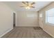 Inviting living room features plush carpet, ceiling fan, natural light, and door to kitchen, creating a cozy space at 3465 Tulip Dr, Decatur, GA 30032