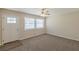 Bright living room with new carpet, white trim, a ceiling fan, and a large window providing plenty of natural light at 3465 Tulip Dr, Decatur, GA 30032
