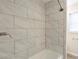 Tiled shower with brushed nickel fixtures and a window, offering a spa-like feel in the bathroom at 3465 Tulip Dr, Decatur, GA 30032