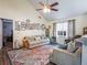 Bright living room featuring a vaulted ceiling, plush sofa, colorful rug, and ample natural light at 45 Side Trail, Covington, GA 30016