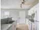 Functional kitchen with white cabinets, modern appliances, granite countertops, and tile flooring at 72 Polar Rock Rd, Atlanta, GA 30315