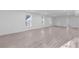 Spacious basement with light wood flooring, recessed lighting, and three large windows providing ample natural light at 7065 Walnut Mill Ct, Cumming, GA 30040