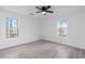 Bright bedroom featuring hardwood flooring and large windows with natural light at 7065 Walnut Mill Ct, Cumming, GA 30040