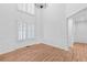 Elegant dining area with high ceilings, hardwood floors, and large windows with shutter, perfect for gatherings at 7065 Walnut Mill Ct, Cumming, GA 30040
