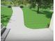 Long concrete driveway leading to a modern home with lush green lawns and beautiful landscaping at 7065 Walnut Mill Ct, Cumming, GA 30040