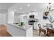 Modern kitchen with granite countertops, stainless steel appliances, and an adjoining breakfast area at 7065 Walnut Mill Ct, Cumming, GA 30040