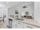 Open concept kitchen with granite countertops, stainless steel appliances, and seamless connection to living area at 7065 Walnut Mill Ct, Cumming, GA 30040