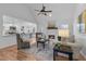 Bright living room with hardwood floors, ceiling fan, and a cozy fireplace at 7065 Walnut Mill Ct, Cumming, GA 30040