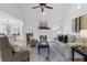 Bright and airy living room featuring a fireplace, neutral décor, and seamless flow to the dining area at 7065 Walnut Mill Ct, Cumming, GA 30040