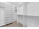Bright, white walk-in closet with extensive shelving and hanging rods for optimal storage solutions at 7065 Walnut Mill Ct, Cumming, GA 30040