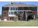 Brick home with covered deck offers scenic backyard views, providing a perfect blend of comfort and style at 838 Natchez Valley Trce, Grayson, GA 30017