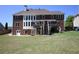 Large brick home showcases a walkout basement and upper level deck, overlooking a well-kept backyard at 838 Natchez Valley Trce, Grayson, GA 30017