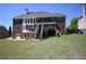 Spacious backyard offers a large brick home with a deck and ample space for outdoor activities at 838 Natchez Valley Trce, Grayson, GA 30017