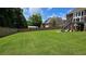 Beautifully kept backyard with a lush lawn, wood fence, and a large deck with stairs at 838 Natchez Valley Trce, Grayson, GA 30017