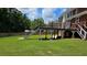 Spacious backyard featuring a deck with stairs overlooking the lush, green lawn at 838 Natchez Valley Trce, Grayson, GA 30017