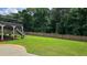 Expansive backyard featuring a well-maintained lawn and a classic wood fence at 838 Natchez Valley Trce, Grayson, GA 30017