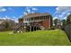 Spacious backyard featuring a well-maintained lawn and second-story deck at 838 Natchez Valley Trce, Grayson, GA 30017