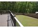 A beautiful backyard featuring a wooden fence and a deck made with wood and black railings at 838 Natchez Valley Trce, Grayson, GA 30017
