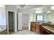 Spacious bathroom with dual vanities, large mirrors, and an adjoining room view at 838 Natchez Valley Trce, Grayson, GA 30017