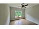 Cozy bedroom with wood floors, a ceiling fan and a large window providing natural light at 838 Natchez Valley Trce, Grayson, GA 30017