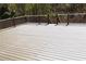 Large wooden deck with white railings, offering a great outdoor space with a view of the natural landscape and greenery at 838 Natchez Valley Trce, Grayson, GA 30017